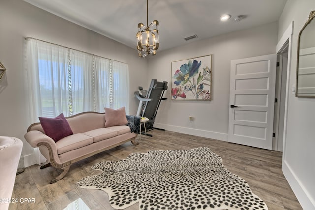 living room with a notable chandelier and light wood-type flooring