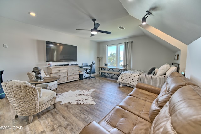 living room featuring hardwood / wood-style flooring, ceiling fan, and lofted ceiling