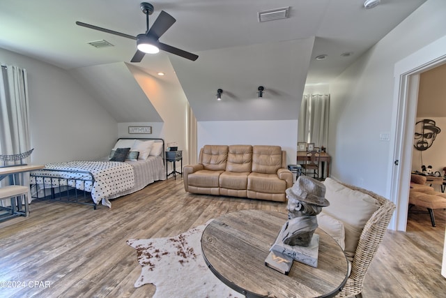 bedroom featuring wood-type flooring, ceiling fan, and lofted ceiling