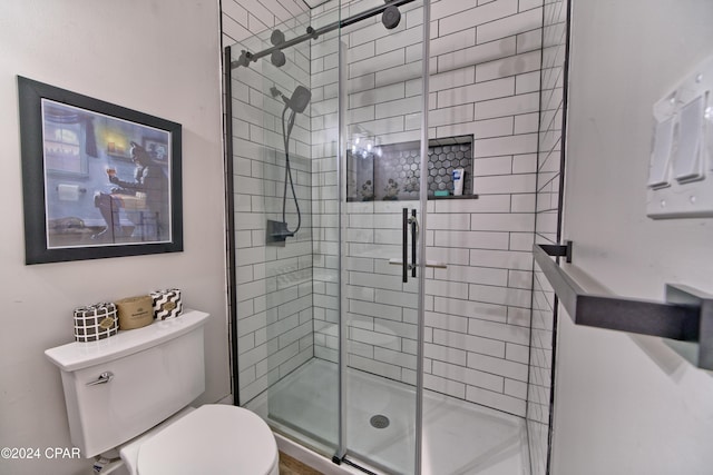 bathroom with an enclosed shower and toilet