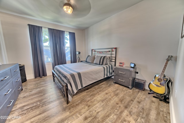 bedroom with ceiling fan and light hardwood / wood-style floors