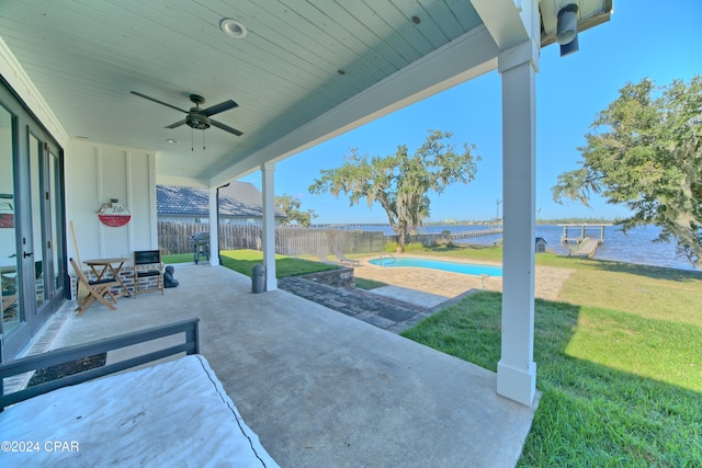 view of patio featuring ceiling fan and a water view