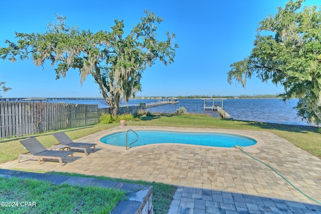 view of pool featuring a boat dock, a water view, and a patio area