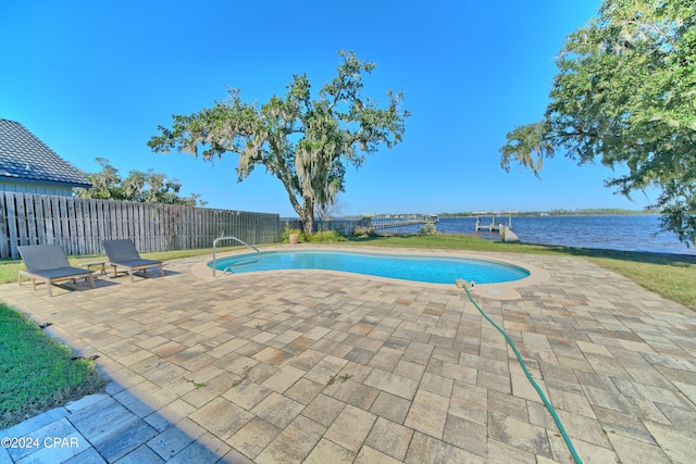 view of swimming pool featuring a patio area and a water view