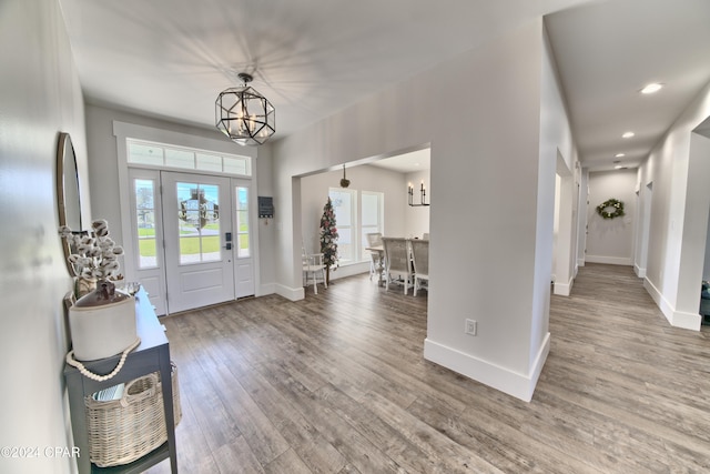 foyer entrance with hardwood / wood-style floors and an inviting chandelier