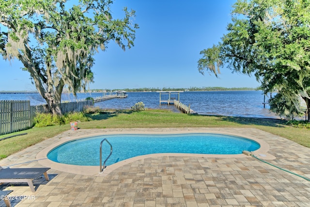 view of pool with a boat dock, a water view, and a patio