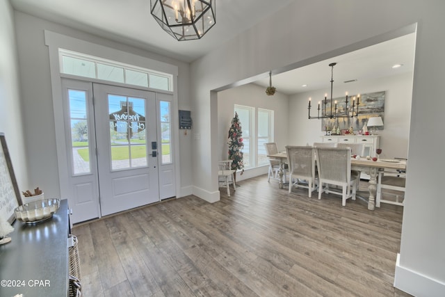 entryway featuring hardwood / wood-style floors and a chandelier