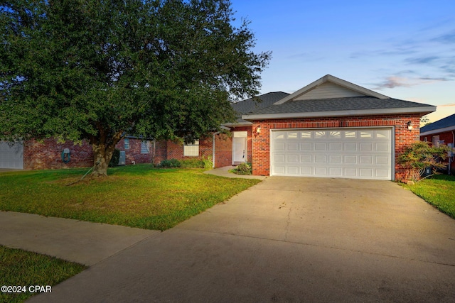 view of front of home featuring a yard and a garage