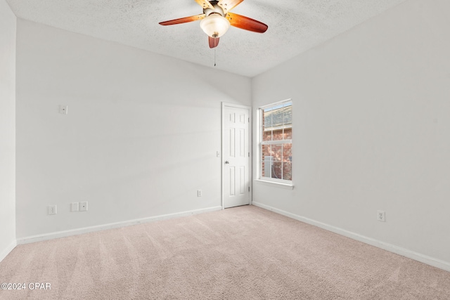 unfurnished room featuring carpet, a textured ceiling, and ceiling fan