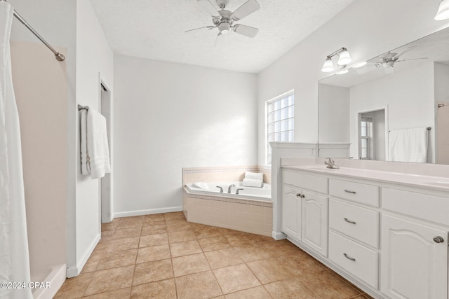 bathroom featuring tile patterned floors, tiled tub, ceiling fan, and a textured ceiling