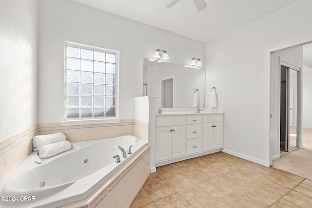 bathroom featuring vanity, tiled bath, tile patterned floors, and ceiling fan