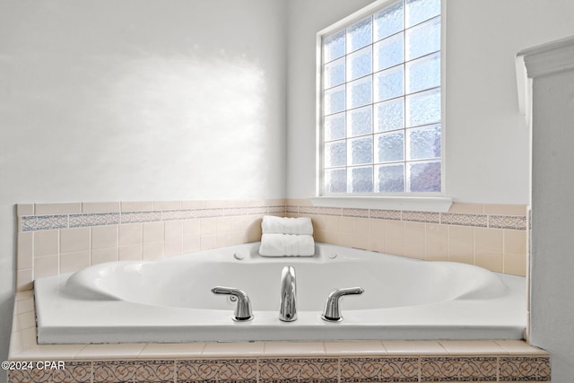 bathroom with a relaxing tiled tub