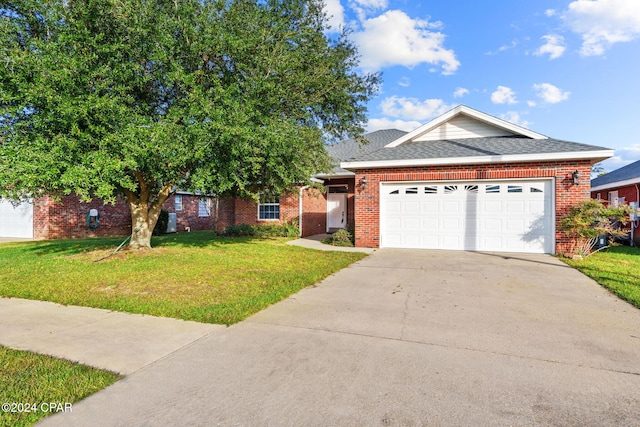 view of front of home with a garage and a front lawn