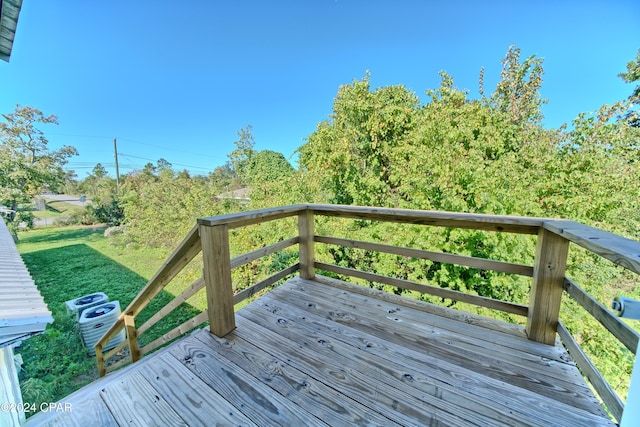 wooden deck featuring central AC unit