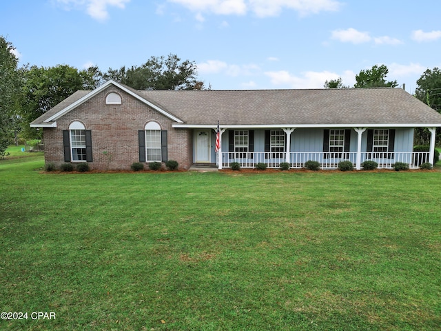 18496 NE Live Oak Ln, Blountstown, FL 32424 - ranch-style home with brick siding, a front yard, board and batten siding, and covered porch