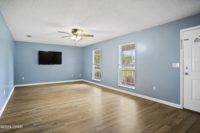 18496 NE Live Oak Ln, Blountstown, FL 32424 - unfurnished living room with a ceiling fan, wood finished floors, visible vents, and a textured ceiling