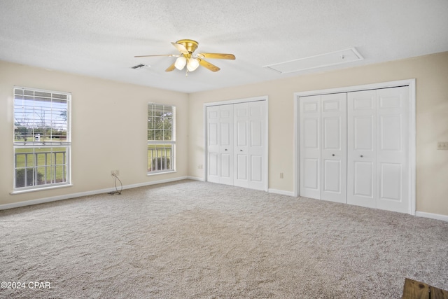 18496 NE Live Oak Ln, Blountstown, FL 32424 - unfurnished bedroom featuring multiple closets, ceiling fan, carpet floors, baseboards, and visible vents