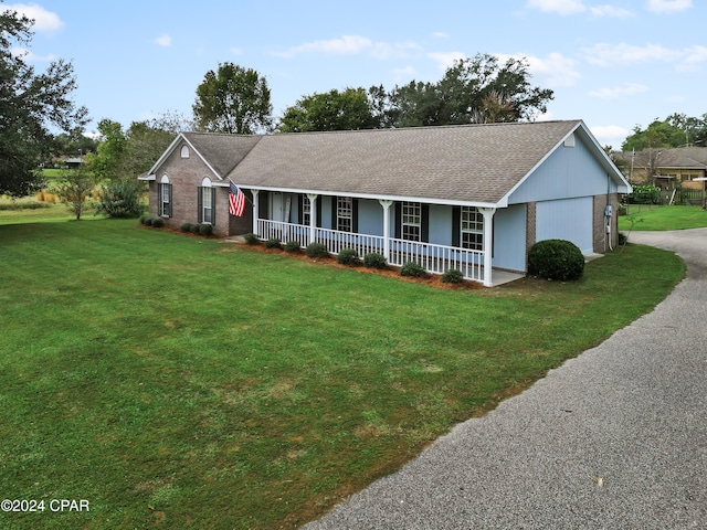 single story home with a front yard and covered porch