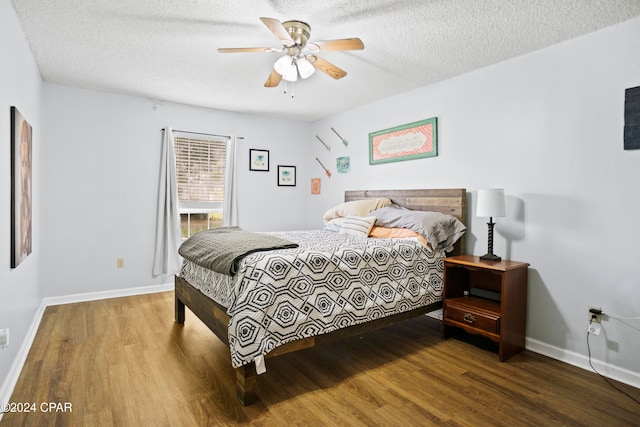 bedroom featuring hardwood / wood-style flooring, ceiling fan, and a textured ceiling