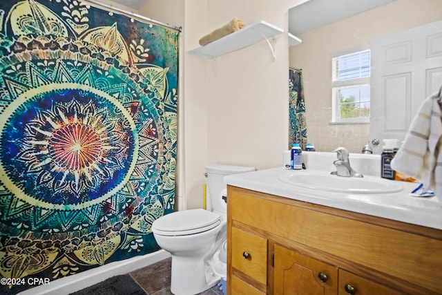 bathroom featuring tile patterned floors, vanity, and toilet