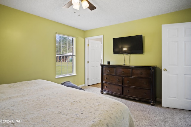 18496 NE Live Oak Ln, Blountstown, FL 32424 - bedroom with baseboards, a textured ceiling, a ceiling fan, and light colored carpet