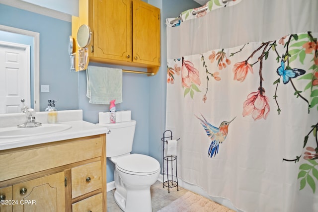 bathroom featuring tile patterned flooring, vanity, toilet, and a shower with curtain