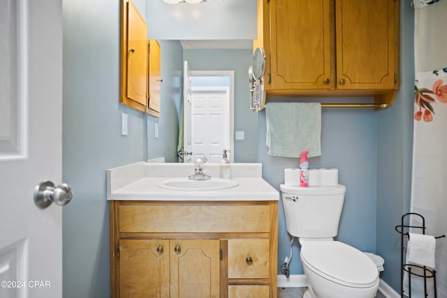 bathroom featuring vanity and toilet