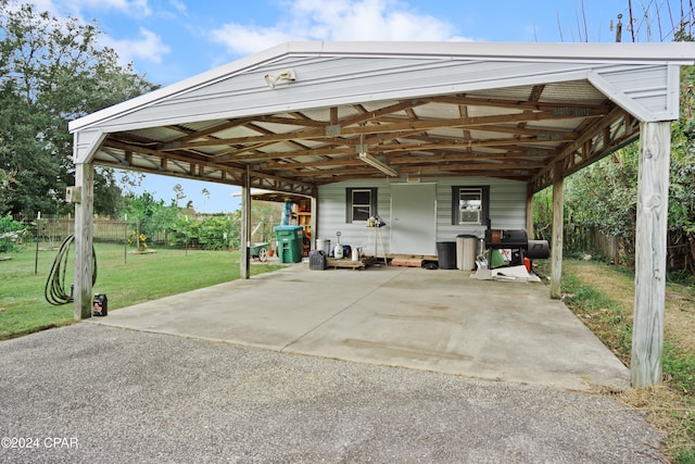 view of parking with a yard and a carport