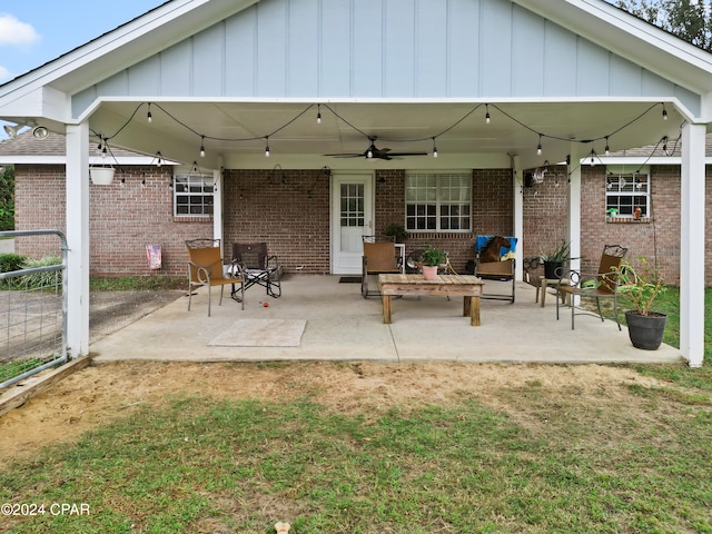 rear view of property featuring a lawn, ceiling fan, and a patio area