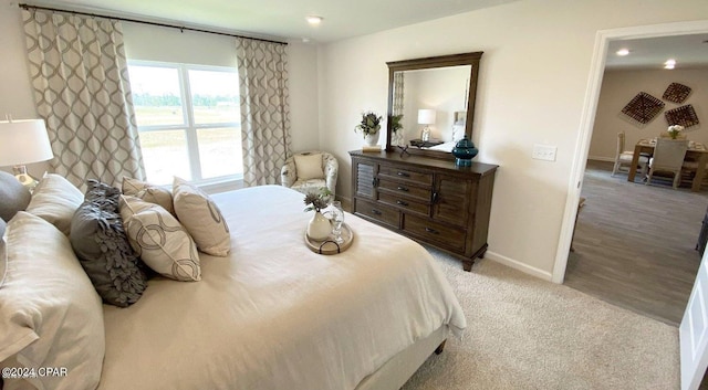 bedroom featuring light carpet