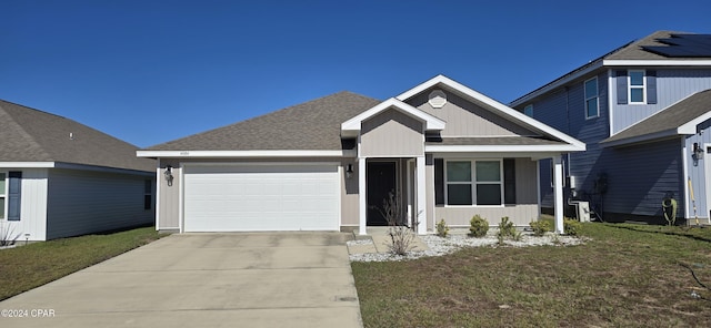 view of front of home featuring a front lawn and a garage