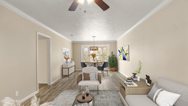 living room featuring ceiling fan, crown molding, wood-type flooring, and a textured ceiling