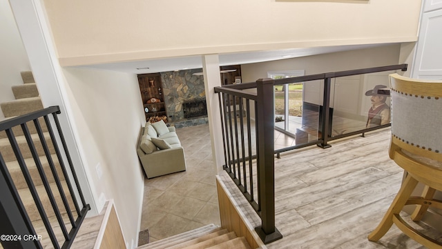 stairs with a stone fireplace