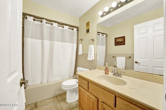 kitchen with a textured ceiling, light stone counters, sink, and white appliances