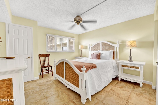 bedroom with a textured ceiling, a ceiling fan, and baseboards