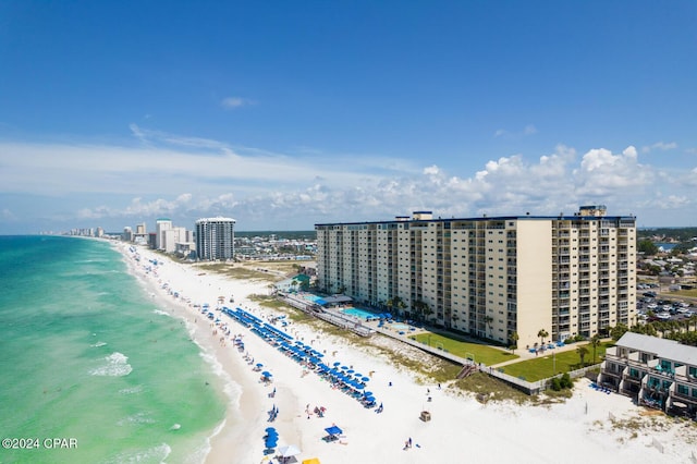 aerial view featuring a view of city, a beach view, and a water view