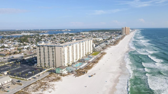 birds eye view of property featuring a view of city, a water view, and a beach view