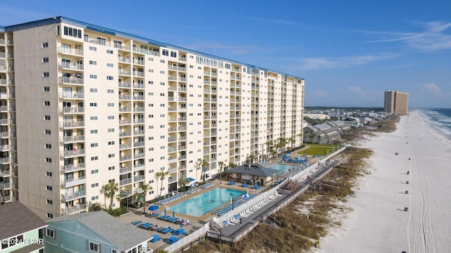 view of property with a beach view and a water view