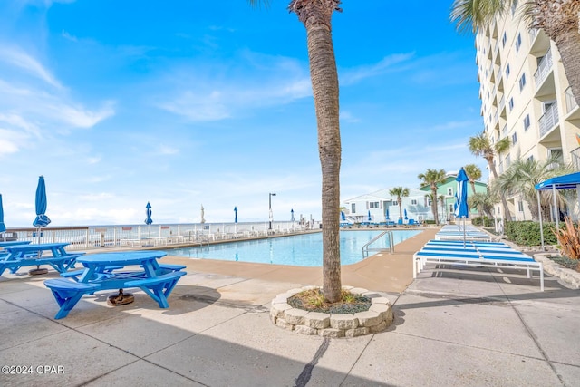 view of pool with a water view