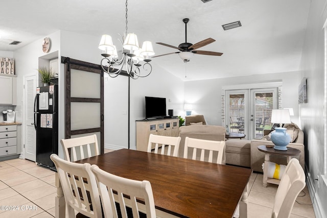 dining area with lofted ceiling, french doors, light tile patterned flooring, and ceiling fan with notable chandelier