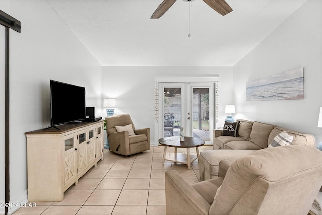 tiled living room with french doors, ceiling fan, and lofted ceiling