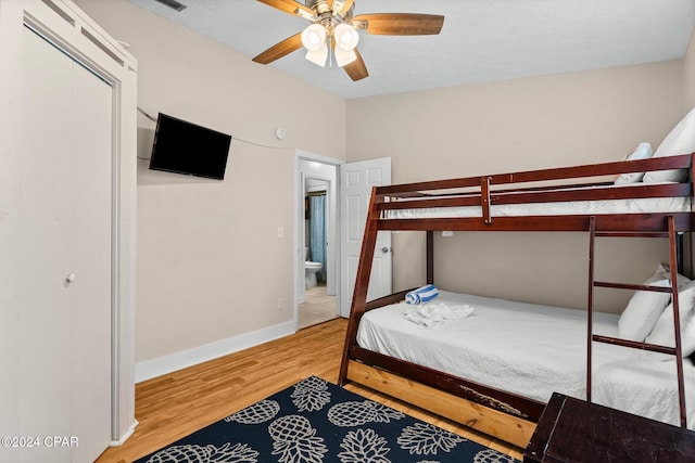 bedroom featuring wood-type flooring, a closet, and ceiling fan