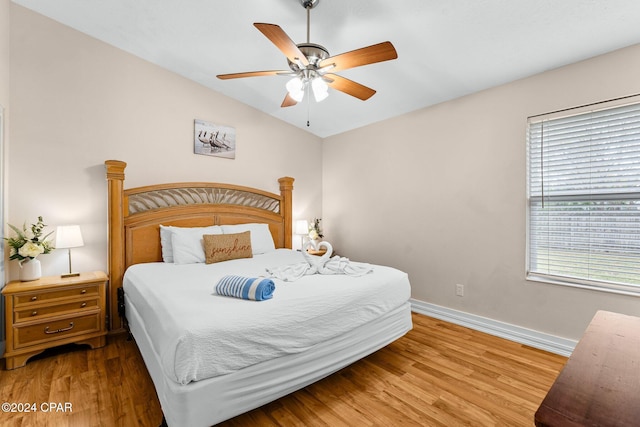 bedroom with hardwood / wood-style floors, ceiling fan, and lofted ceiling