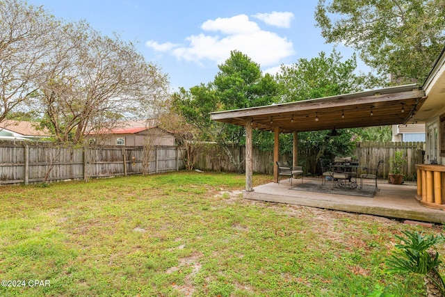 view of yard with ceiling fan and a deck