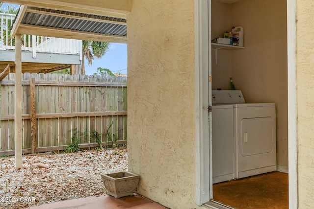 clothes washing area with washer and clothes dryer