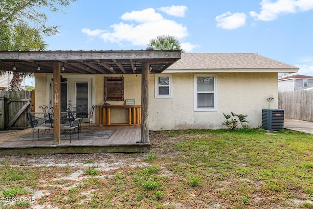 back of house with a yard, central AC unit, and a wooden deck