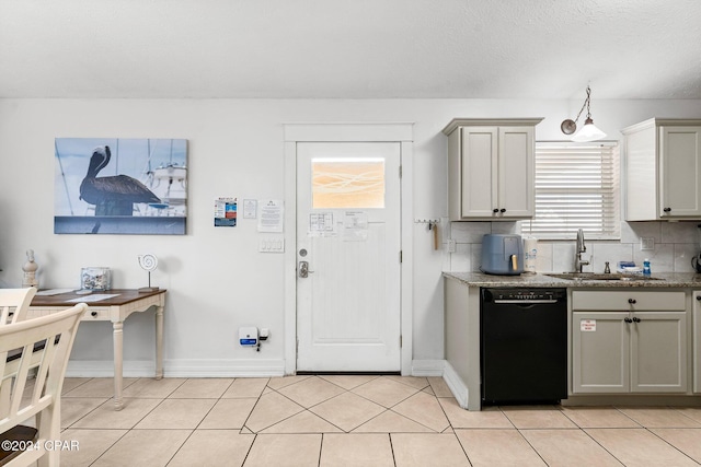 kitchen featuring gray cabinetry, sink, decorative backsplash, light tile patterned floors, and black dishwasher