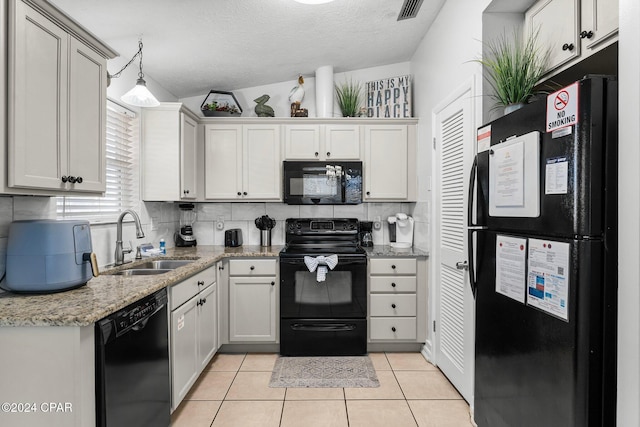 kitchen featuring black appliances, white cabinets, sink, hanging light fixtures, and a textured ceiling