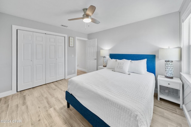 bedroom featuring ceiling fan, a closet, and light hardwood / wood-style flooring