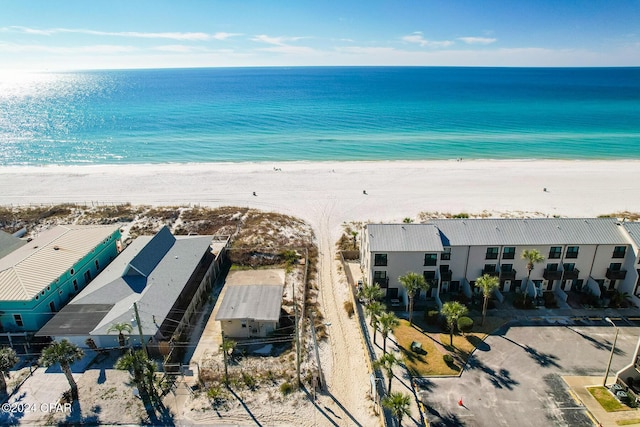 drone / aerial view featuring a water view and a beach view